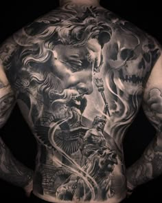 the back of a man with tattoos on his body