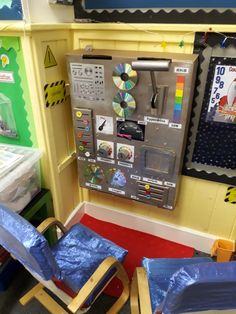 there are two chairs in front of a toy machine