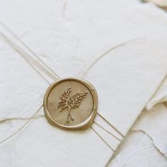 a wax stamp with a maple leaf on it sitting on top of some white paper