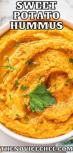 sweet potato hummus served in a white bowl with parsley garnish on top