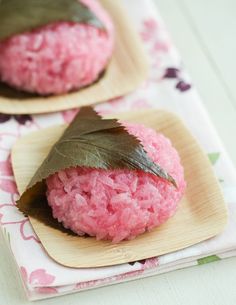 two small pink cookies with leaves on top