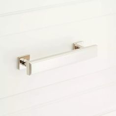 an image of a bathroom door handle on a white wall with horizontal lines in the background