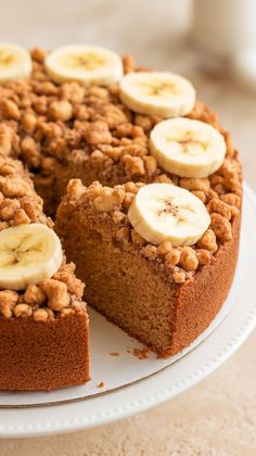 a cake with sliced bananas and nuts on top