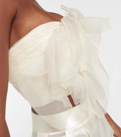 style details: Bring Danielle Frankel's romantic aesthetic to your cocktail edit with the Macie strapless bustier. The ethereal style is crafted from frothy silk organza layers into the shape of a rose and has soft boning for a structured look. material: 100% silk; care instructions: dry clean; zipped back; Made in the USA; built-in bustier; Designer colour name: Ivory.size & fit: If you have any questions, please call our customer care team at 0808 101 3473 True to size; Strapless; Internal boned corset for support; Fitted; Mid-weight material; Cropped; Padded top; The model seen in the picture is 178cm-5'10' and wearing a size US 4.delivery & free returns: All orders are shipped worldwide via our affiliate couriers DHL or UPS. Please see the shipping method as well as shipping costs and Spring Wedding Corset With Ruffles, Elegant Strapless Bodice, Elegant Strapless Evening Bodice, Elegant Sheer Bodice Corset With Spaghetti Straps, Strapless Tulle Bodice, Elegant Corset With Sheer Bodice And Spaghetti Straps, Elegant Sheer Corset With Spaghetti Straps, Elegant Spaghetti Straps Bodice With Boned Bodice, Elegant Tulle Corset With Fitted Bodice