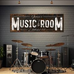 there is a sign that says music room and drums in front of the drum set