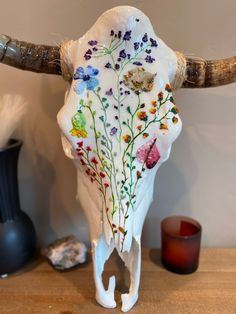 an animal skull with flowers painted on it