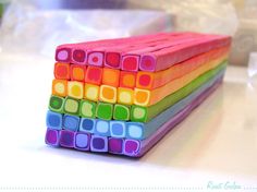 a stack of colored blocks sitting on top of a table