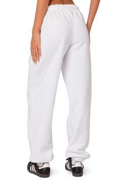 A cozy cotton blend keeps you feeling your best no matter what the day brings when you choose these oversized sweatpants. Elastic waist Side-seam pockets Elastic cuffs 50% cotton, 50% polyester Machine wash, dry flat Imported Basic Cotton Sweats For Lounging, Comfortable White Baggy Bottoms, Oversized Solid Color Sweatpants With Elastic Waistband, Oversized Solid Color Joggers For Loungewear, Oversized Solid Cotton Sweatpants, Solid Color Baggy Sweatpants With Straight Hem, Baggy Comfortable Cotton Sweats, Oversized Sweatpants With Pockets And Straight Hem, Baggy Comfortable Sweats With Pockets