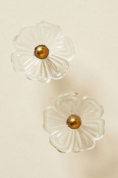 two clear glass flowers with gold centers