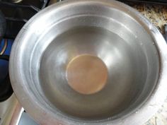 a metal bowl sitting on top of a stove