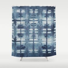 a blue and white shower curtain with an abstract design