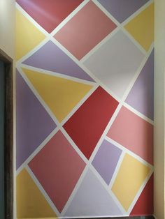 the wall is painted with different colors and shapes