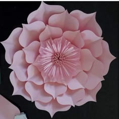 a large pink paper flower sitting on top of a table