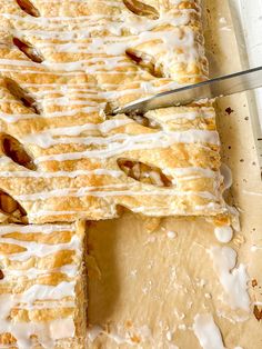 a close up of a pastry on a cutting board with a knife in the middle