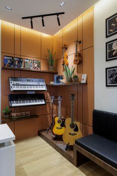 a living room with guitars and musical instruments on the wall next to a piano keyboard