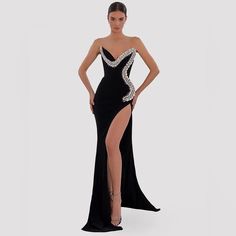 Turn Heads In This Timeless Sparkly Body Velvet Dress Featuring A Rhinestones Embellished Neckline And Side Design, Fitted High Waist And Side Split. A Great Dress For Red Carpet Events And Evenings. Available Sizes: S, M & L 2 Weeks Delivery From Order Date #Velvetdress #Blackvelvet #Eveningdress #Partydress #Weddings #Bodycondress #Crystals #Rhinestones Rhinestone Evening Dress For Gala, Black Rhinestone Gown For Evening, Cocktail Evening Dress With Rhinestones And Floor-length, Black Rhinestone Evening Gown, Formal Black Gown With Rhinestones, Bedazzled Evening Dress, Black Rhinestone Dress For Gala, Strapless Rhinestone Evening Dress For Night Out, Black Rhinestone Evening Dress