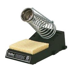 a sponge is being held in front of a metal coil on top of a black stand