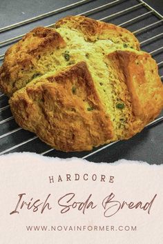 a loaf of irish soda bread sitting on top of a cooling rack next to a piece of paper