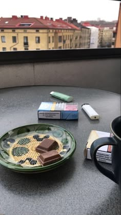 there is a plate with some chocolate on it next to a cup and other items