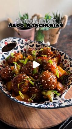 a bowl filled with meat and vegetables on top of a wooden table next to potted plants