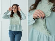 a woman wearing a green blouse and blue jeans is holding her hands up to her ear