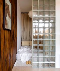 a glass block wall in the hallway between two rooms