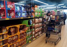 a woman is shopping in a grocery store