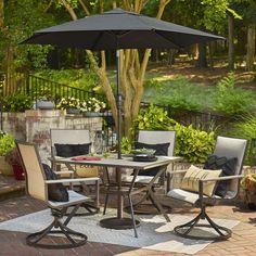 a patio table with chairs and an umbrella