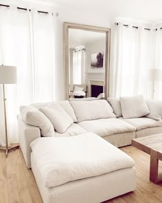 a living room filled with furniture and a large mirror