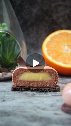 an orange slice sitting on top of a counter next to some other fruits and vegetables