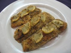 fish with lemon slices on a white plate