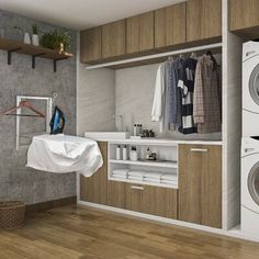 a washer and dryer in a room with wood flooring on the walls