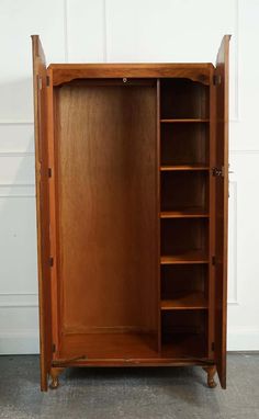 an old wooden armoire with shelves and drawers