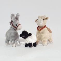 three small crocheted animals standing next to each other