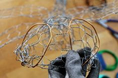 a wire sculpture with scissors in the background