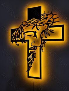 the crucifix with jesus's face is lit up in yellow light