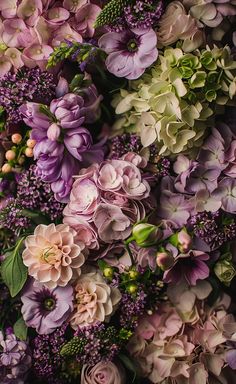 a bunch of flowers that are in the middle of some kind of flower arrangement,