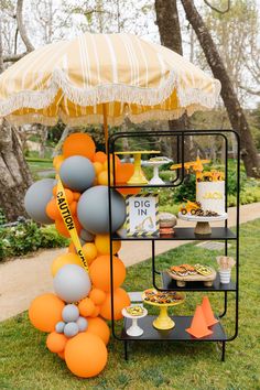 an orange and gray dessert stand with yellow umbrella