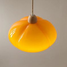 an orange light hanging from a ceiling