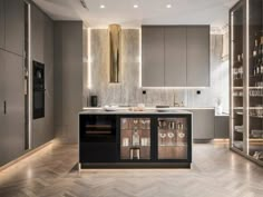 a modern kitchen with an island and wine rack in the center, lighted by recessed lighting