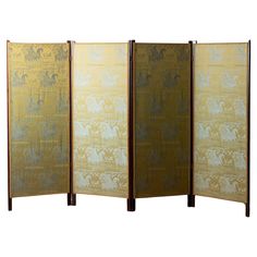 three panel screen with gold and white designs on it, one in the foreground