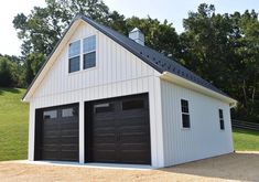 a two car garage in front of a white house