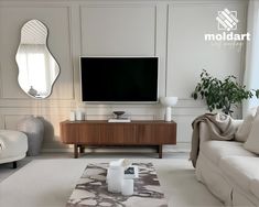 a living room with white furniture and a flat screen tv