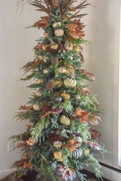 a christmas tree with lots of different types of ornaments on it's top and bottom