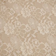 an old lace fabric with white flowers on it