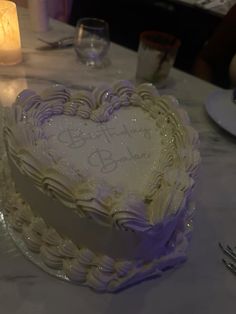 a heart shaped cake sitting on top of a table