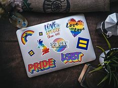 the pride sticker sheet is on top of a table next to some other items