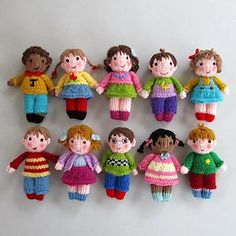 a group of knitted dolls sitting next to each other