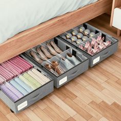 an organized drawer under a bed with shoes and other items in the bins on it