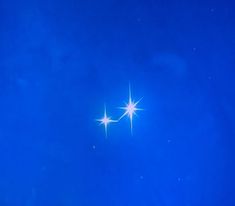 two bright white stars against a blue sky